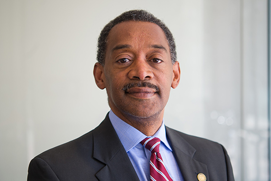 Portrait of Jonathan Woodson in a suit and tie.