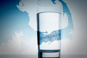 glass of drinking water in front of a map of Cape Cod, Massachusetts
