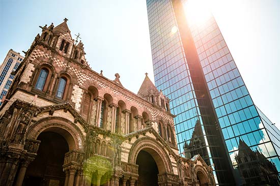 Sunshine hits Trinity Church and the Hancock Building in Copley Square, Boston