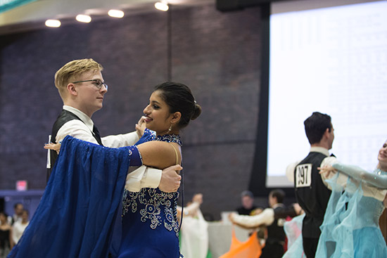 Luke Jones (left) and Ballroom Dance Club president Nikita Varman competing in the rhythm category at the 2017 Terrier Dancesport competition in the Metcalf Ballroom February 19.