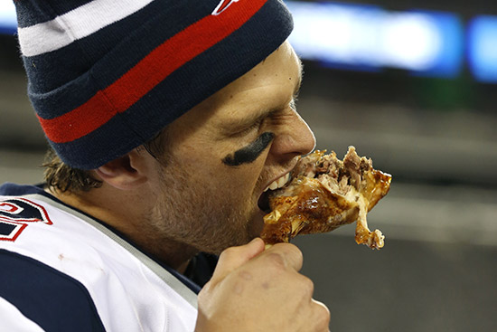 Patriots Quarterback Tom Brady eats a turkey leg