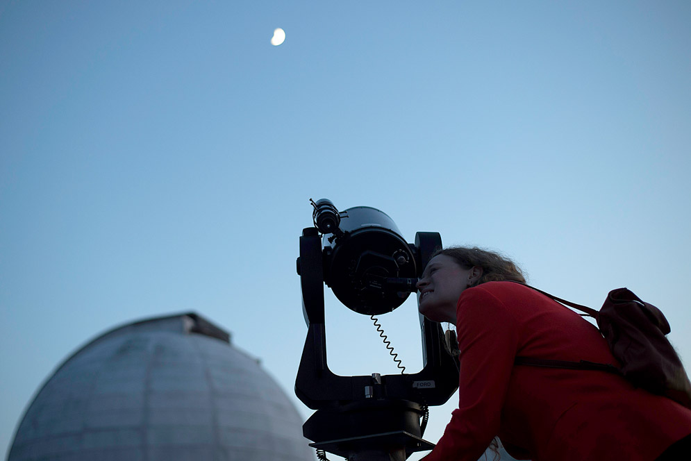 Elizabeth Henehan peers through a telescope to see moon