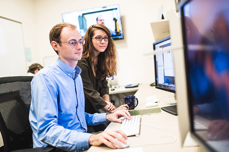 Philip Muirhead and Sheila Sagear looking at computer