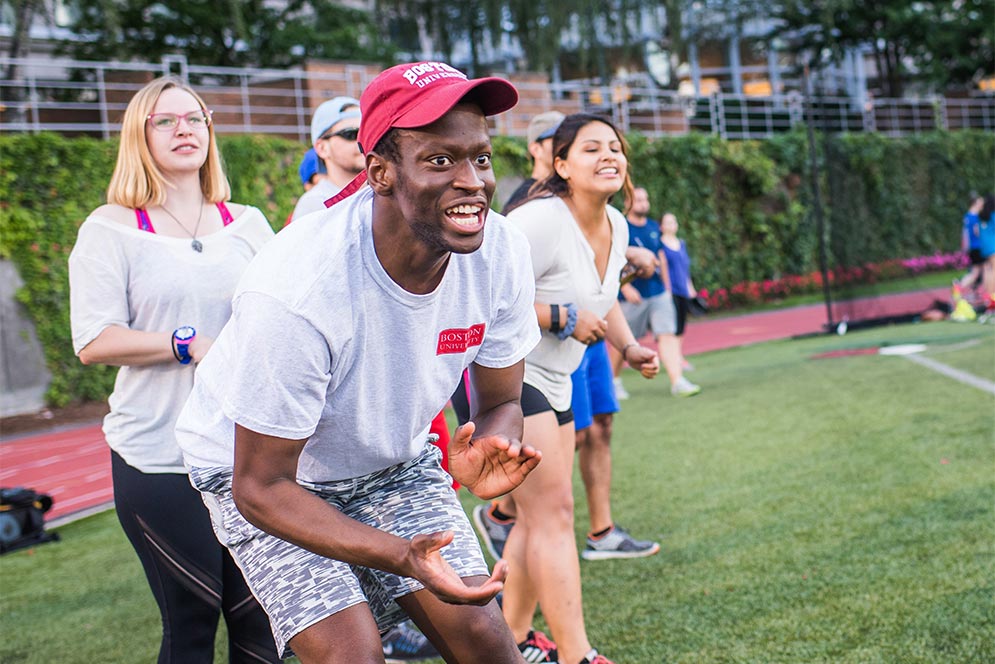 Boston University School of Public Health students cheer on their team mates during a BU Summer Softball League game