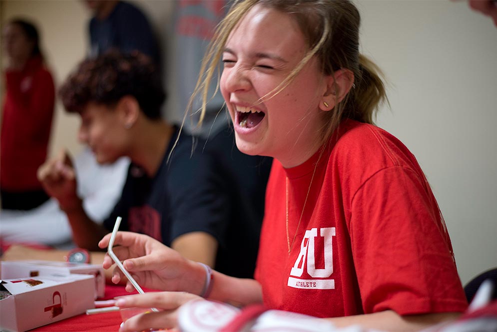 A student reacts to winning a competition during the Terrier Night Out orientation event