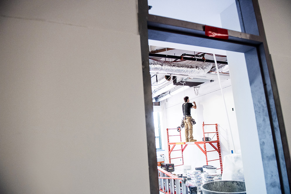 Construction worker doing work to ceiling
