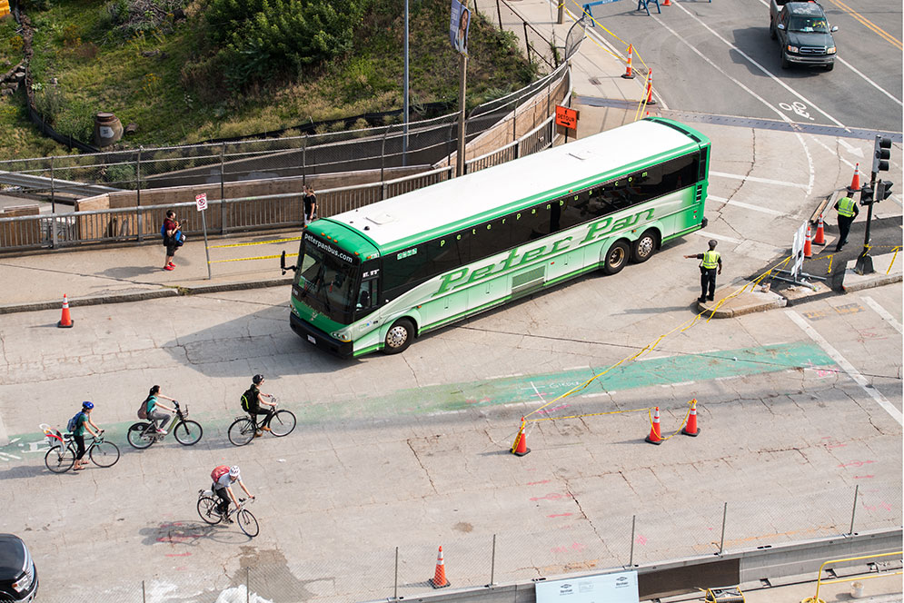 Cops directing traffic on comm ave featuring cyclists and a peter pan bus