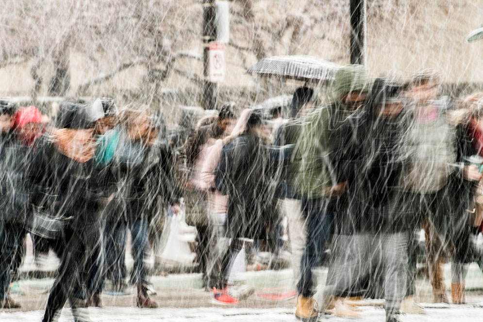 Students walking through a blizzard on campus photo