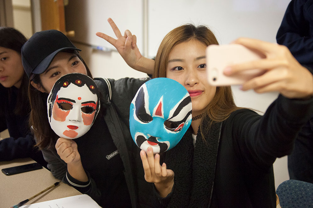 ute, fierce, white for evil, sinister, hypocritical. Sixin Li (CAS’20) (left) and Zuan Zhang (CAS’19) created their own mask at a World Languages & Literatures event