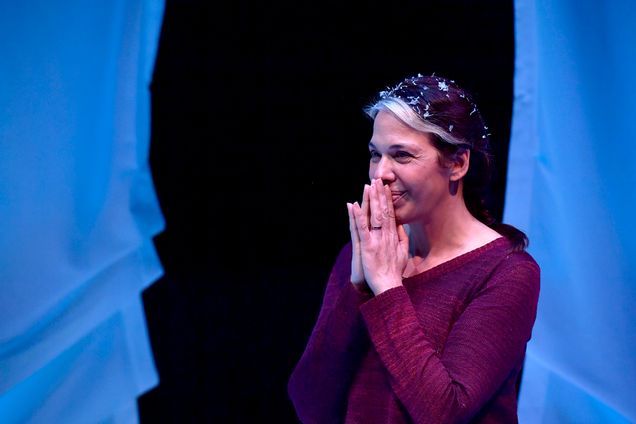 Playwright and actress Melinda Lopez smiling on stage