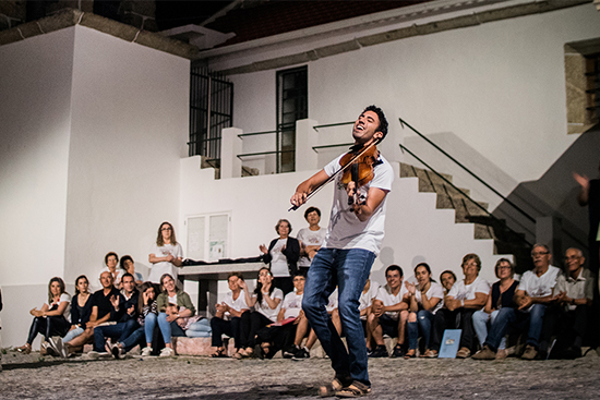 A musician performs on the violin in the mountain village of Bendada, Portugal, part of the Bendada Music Festival.