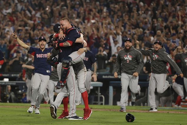 Catcher Christian Vazquez hugs Chris Sale on the pitchers mound celebrating after the Red Sox made the last out to win the 2018 World Series