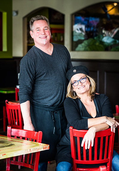 Portrait of Paul and Melina Barber, owners of the Flying Rhino Cafe and Watering Hole in Worcester, Massachusetts, inside their restaurant.