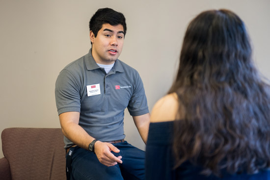 Augustine Jimenez being interviewed while wearing his Residence Life shirt
