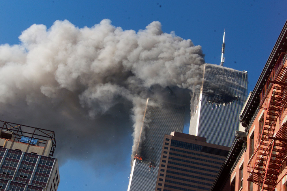 the twin towers smoking as seen from the street a few blocks away