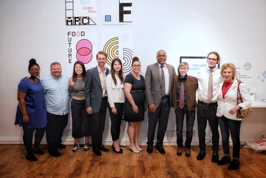 Allegra Fletcher, Ty Furman, Sarah Shin, Paul Dufresne, Choah Kim, Seychelle Dunn-Corbin, Harvey Young, Matt Hufford, Max Bard, and Deborah Kahn standing in front of a wall with posters and art on it