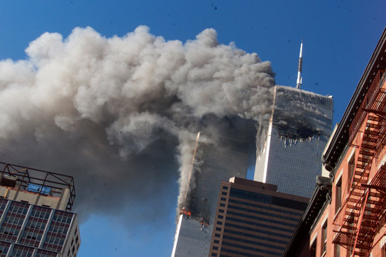 the twin towers smoking as seen from the street a few blocks away