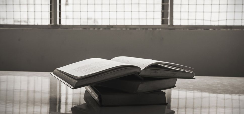 Stack of books on a table in a prison
