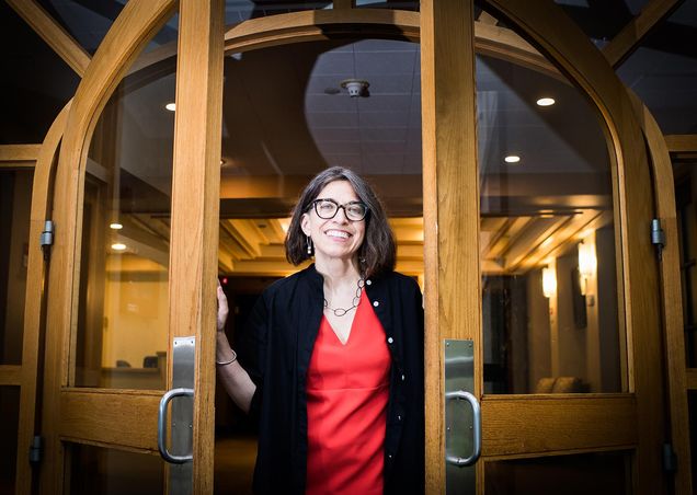 Portrait of Mary L. Churchill, former Vice President of Wheelock College, standing in a doorway.