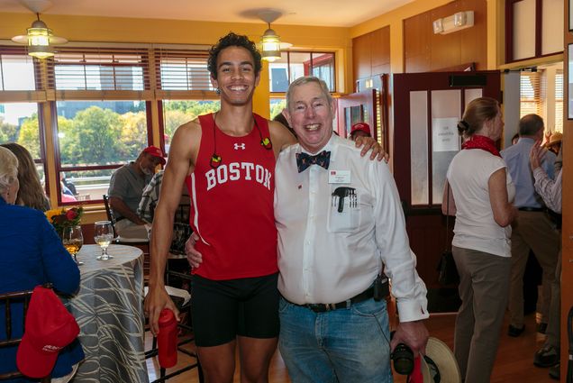 Boston University Terriers rowing team member David Fox poses with fan Ed Boesel during the 2017 Head of the Charles Regatta.