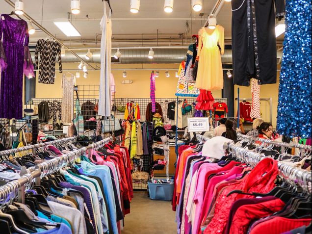 Racks of colorful clothing on display in Goodwill