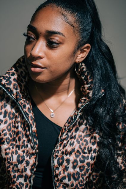Kelsey Russell (CAS’22) poses for a photo in a cheetah print jacket