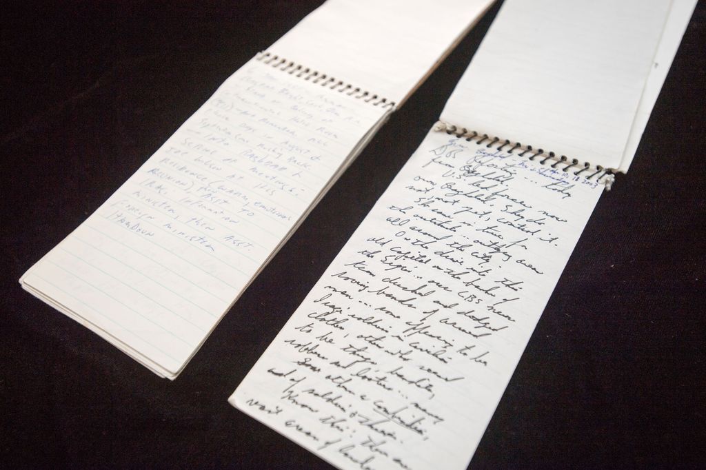 Dan Rather's notebooks from Bagdad in 1991 (left), and his interview with Saddam Hussein in 2003 (right). .