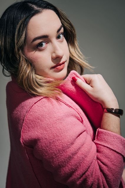 Natalie Held (CAS’21) poses in a pink coat from J-Crew and shows off bracelet from Flare