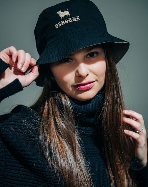 Silvia Velazquez-Gaztelu Ortega wears a reversible rainhat that saws "Osborne" on it