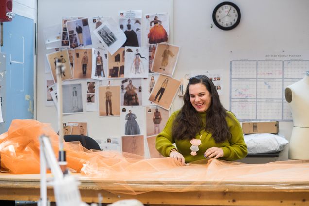 Chelsea Kerl works with a pile of orange tool that will be a skirt