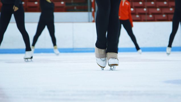 An ice skater skates on the rink in Agganis Areana