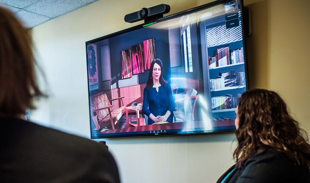 Wheelock College faculty sitting in front of a simulation of a concerned parent during a parent teacher conference