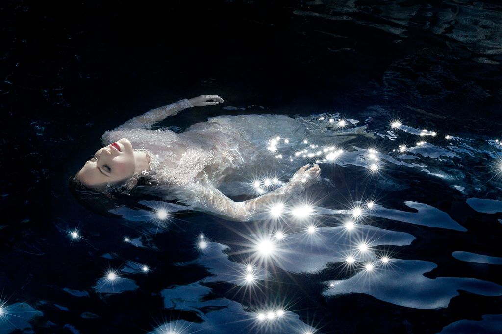 A woman floating in water as part of Elizabeth Caren's Feminine Mystique series.