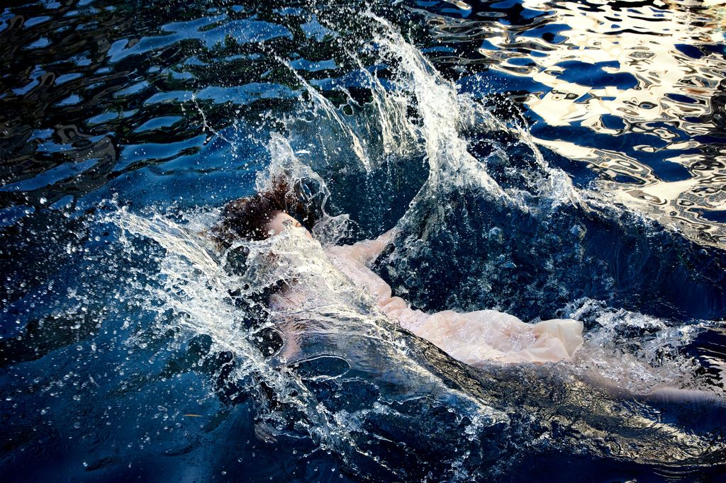 A photo of a woman falling into water as part of Elizabeth Caren's Double Identity series.
