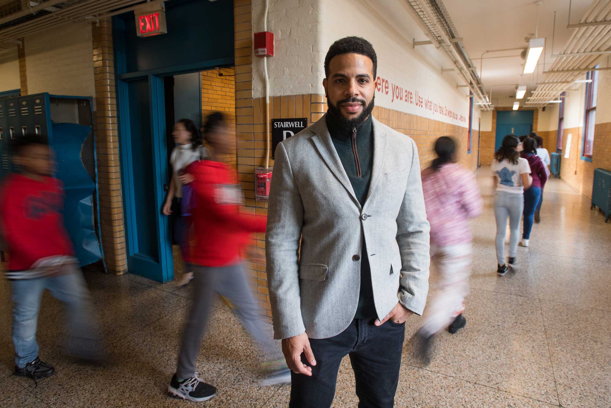 Colin Rose poses for a portrait in a school hallway