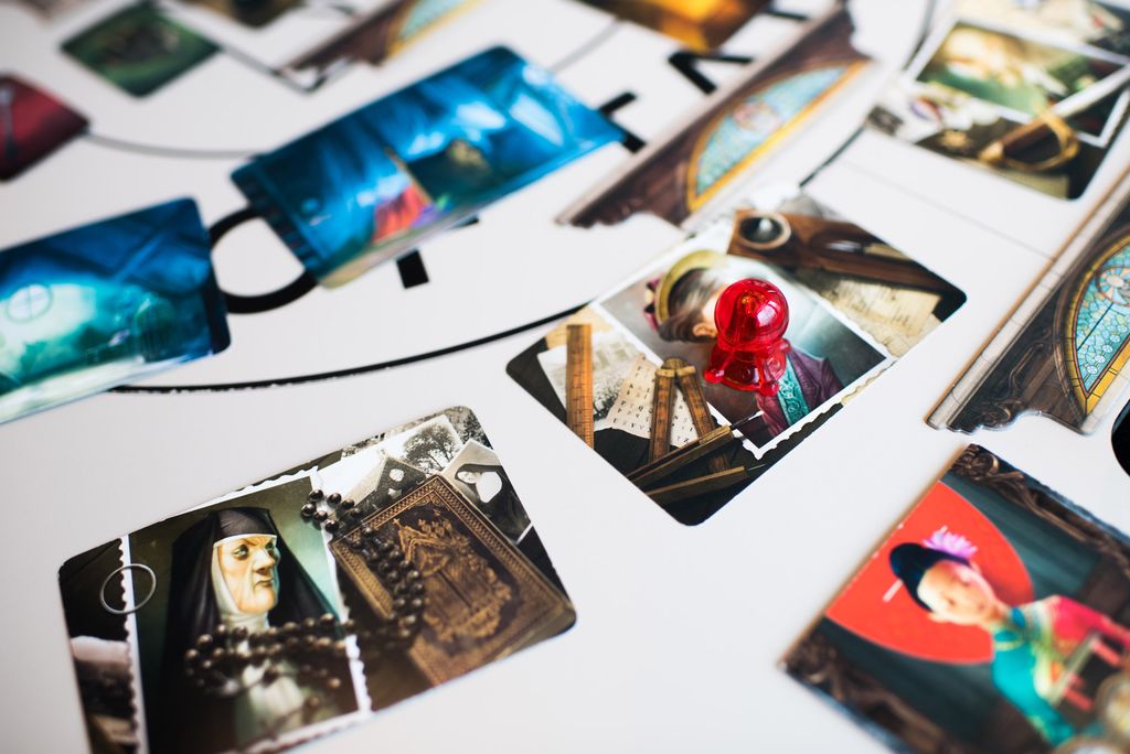 A photo of cards used in the board game Mysterium, spread across the table at Tavern of Tales.