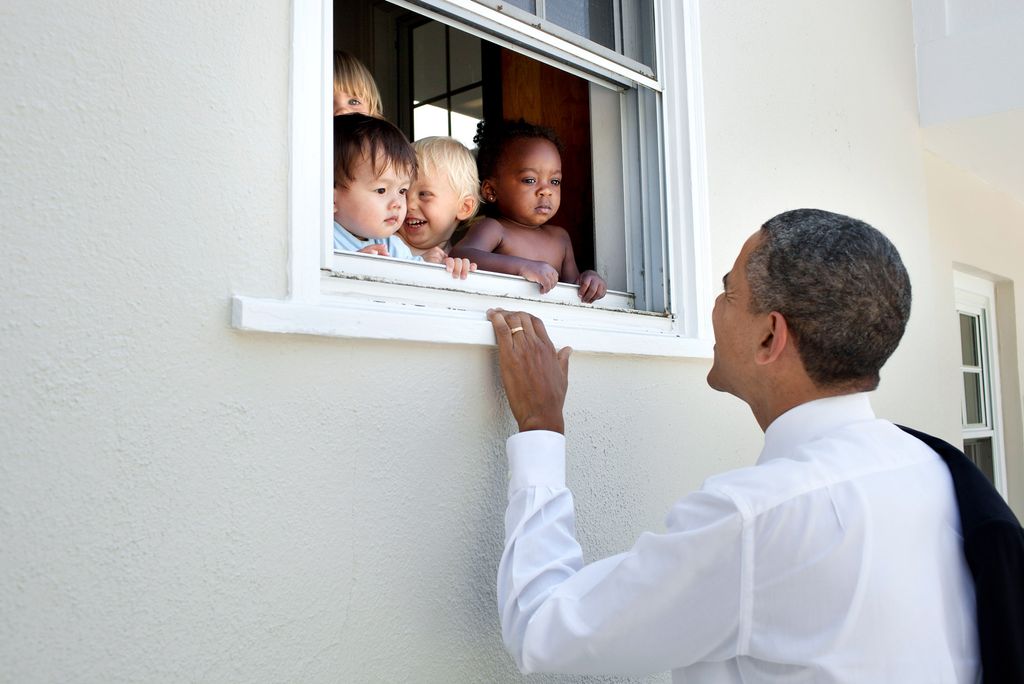 President Obama greets children at a day care facility adjacent to daughter Sasha's school in Bethesda, Maryland, following her 4th grade closing ceremony.