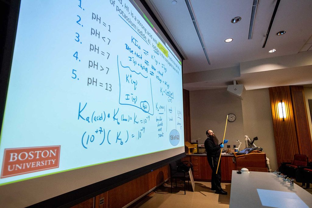 Senior Lecturer in Chemistry Binyomin Abrams gives a remote lecture using a laptop and his smart-podium at Boston University.