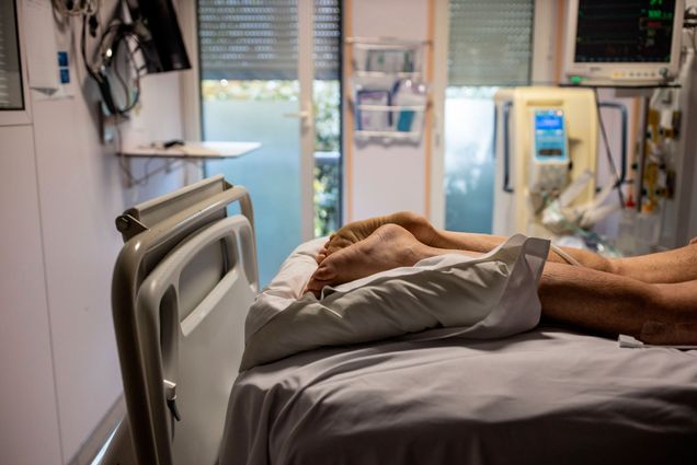 A photo of a COVID-19 patient lying prone on a hospital bed