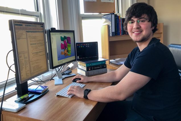 A photo of Reece Huff working at his home computer
