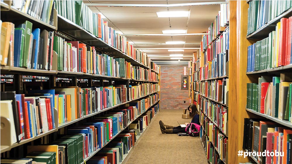 BU themed Zoom virtual background of student reading in the Metcalf Library on the Boston University Charles River Campus