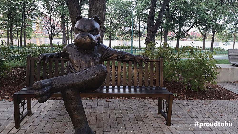 BU themed Zoom virtual background of Rhett the Terrier bench statue on the Boston University Charles River Campus