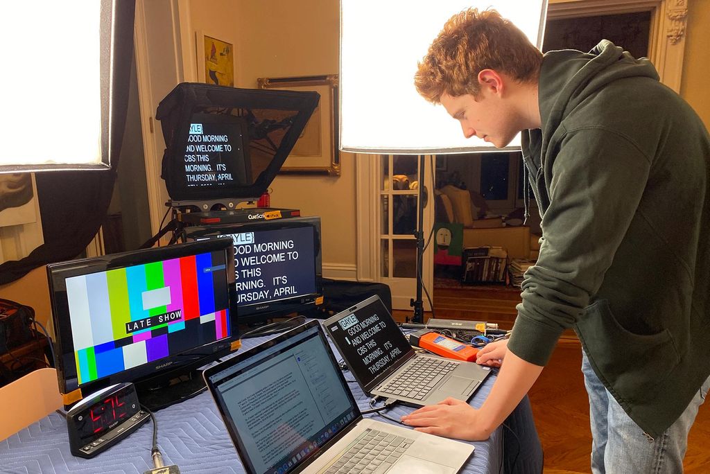 Nick Mason (COM’22) acting as a production assistant to his father, CBS This Morning co-host Anthony Mason, as they broadcast from their Manhattan apartment. Nick stands in front of two laptop screens and two additional screens that say "Good Morning and welcome to CBS This Morning"
