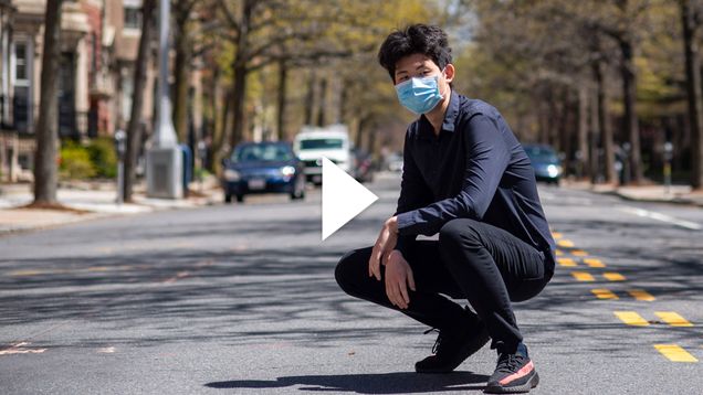 Jiaxin Tong on a deserted Bay State Road. A white video play button appears over the image.