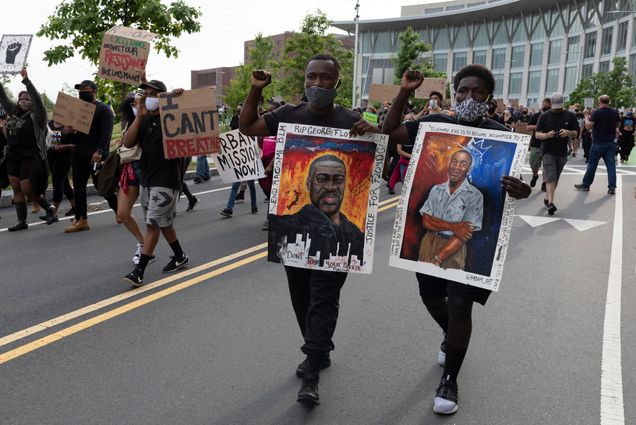 On Saturday, June 6, people carried signs protesting police brutality at the University of Massachusetts in Boston after the death of George Floyd.