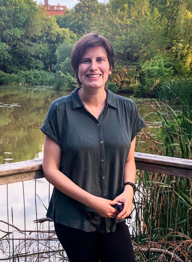 Portrait of Janet Monroe (MED’22) in a dark shirt in front of a pond.