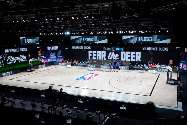 A photo of n empty court at the scheduled start of an NBA basketball first round playoff game between the Milwaukee Bucks and the Orlando Magic, Wednesday, Aug. 26, 2020, in Lake Buena Vista, Fla.
