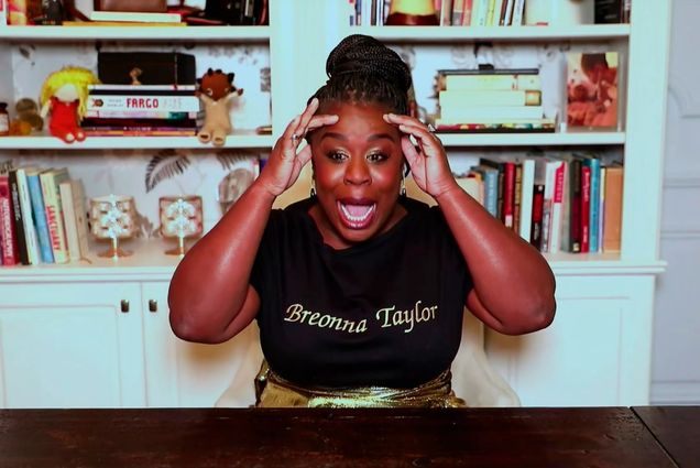 Photo of Uzo Aduba wearing a black t-shirt that says "Breonna Taylor" on it in gold, as she remotely accepts the Emmy for Outstanding Supporting Actress in a Limited Series or Movie for "Mrs. America" during the 72nd Emmy Awards telecast on Sunday, Sept. 20, 2020.