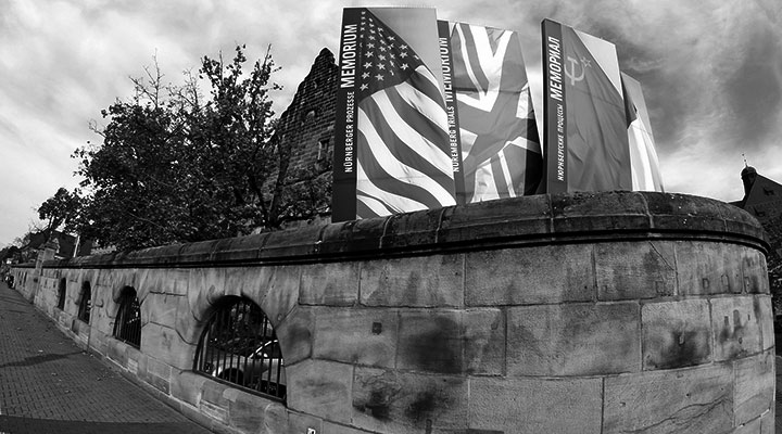 A photo of a brick wall with flags on top of it