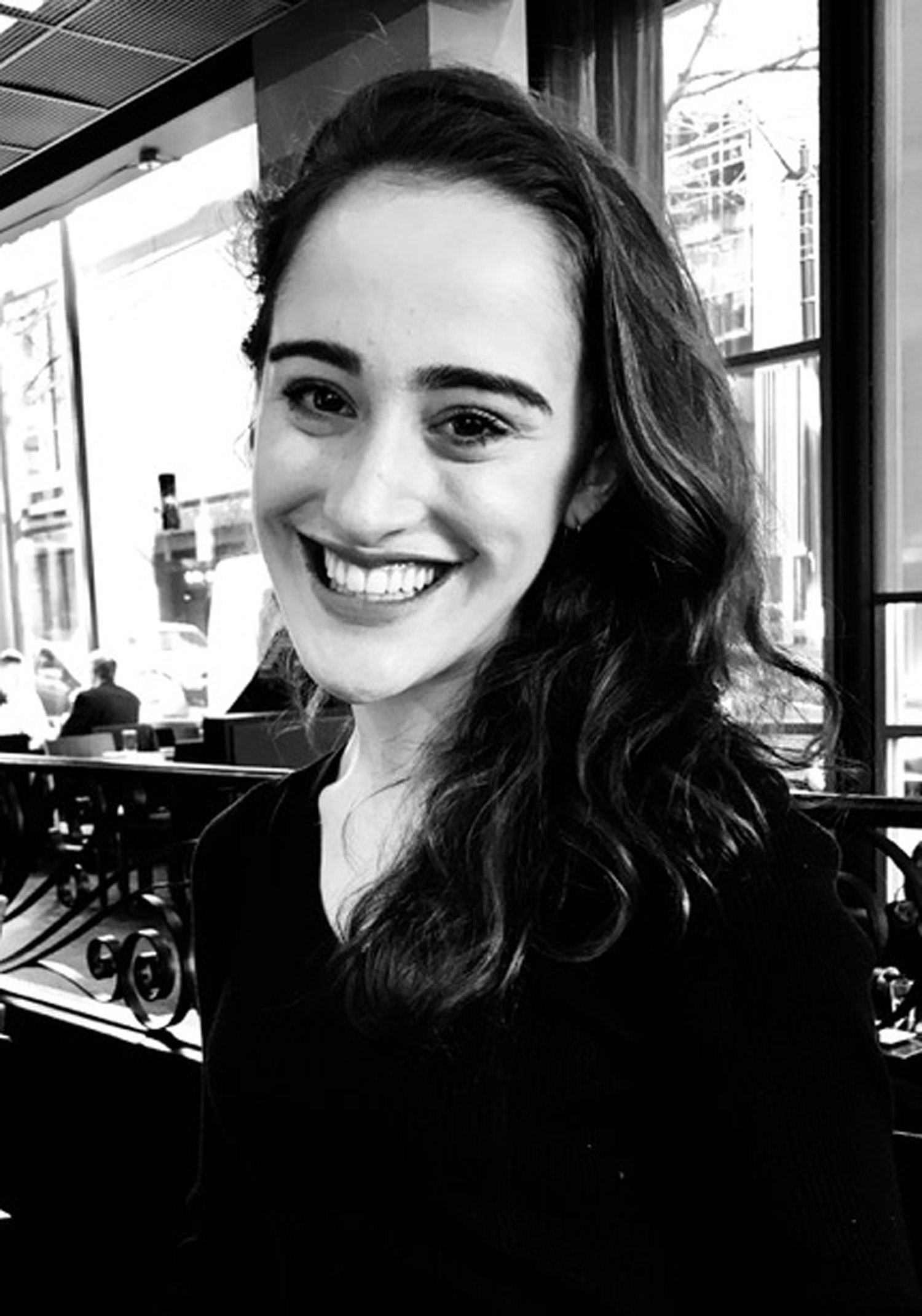 A black and white headshot of Lena Papadakis smiling